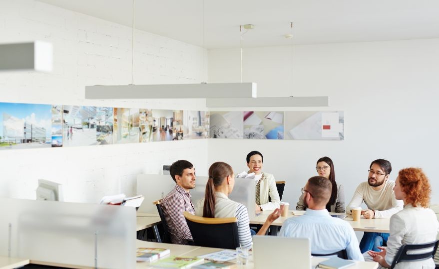 A leader guiding a team discussion in a modern office environment to illustrate authentic leadership.