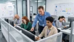 Manager micromanaging employees as they work at individual stations